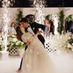 Bride and groom dancing with cold-spark fountains and white florals