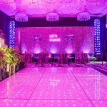 Pink LED dance floor and sparkle backdrop reading Let's Dance