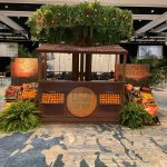 Citrus market stand with orange crates and tropical plants