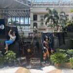 Pirate-themed scene with a skull flag and climbing figure in an atrium