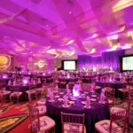 Gala ballroom with magenta uplighting and large video screens