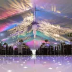 White starlight dance floor in a tent with leaf-pattern gobo lighting